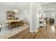 Open-concept dining room featuring hardwood floors, stylish light fixture and decorative shelving at 7483 Hawks Cir, Hanahan, SC 29410