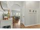 Bright entryway featuring hardwood floors, neutral walls, and an archway leading to the living area at 7483 Hawks Cir, Hanahan, SC 29410