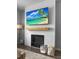 Bright living room with shiplap fireplace, wooden mantle, and large screen TV at 7483 Hawks Cir, Hanahan, SC 29410