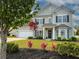 Charming two-story home featuring a well-maintained lawn, landscaping and attached two car garage at 7483 Hawks Cir, Hanahan, SC 29410
