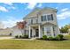 Charming two-story home featuring a well-maintained lawn, a two-car garage, and inviting front entry at 7483 Hawks Cir, Hanahan, SC 29410