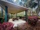 Inviting gazebo featuring a picnic table with green support columns and a neutral roof surrounded by landscaping at 7483 Hawks Cir, Hanahan, SC 29410