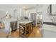 Bright kitchen with stainless steel appliances, quartz countertops, and a wooden island at 7483 Hawks Cir, Hanahan, SC 29410