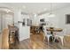 Open concept kitchen featuring white cabinets, a wooden island, stainless steel appliances, and dining area at 7483 Hawks Cir, Hanahan, SC 29410