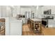 Well-lit kitchen with stainless steel appliances, white cabinets, and a wooden island at 7483 Hawks Cir, Hanahan, SC 29410