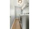 Bright laundry room with modern white washer and dryer and convenient shelving at 7483 Hawks Cir, Hanahan, SC 29410