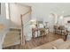 Entryway with stairs, decor table, kitchen counter with chairs, and wood floors at 7483 Hawks Cir, Hanahan, SC 29410