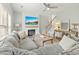 Spacious living room with a large gray sectional sofa, fireplace, and TV at 7483 Hawks Cir, Hanahan, SC 29410