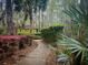 Scenic view of a meandering gravel path leading to a charming gazebo surrounded by lush greenery and landscaping at 7483 Hawks Cir, Hanahan, SC 29410