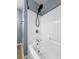 Close up of a newly renovated shower with white tile and black fixtures at 7483 Hawks Cir, Hanahan, SC 29410