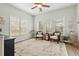 A sun room with neutral colors, many windows, a ceiling fan, and wicker furniture at 7483 Hawks Cir, Hanahan, SC 29410
