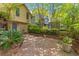 Backyard brick patio with landscaping and entrance to tan home at 753 Lake Frances Dr, Charleston, SC 29412