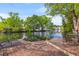 Outdoor waterfront deck with two lounge chairs and a table with chairs, perfect for relaxing outdoors at 753 Lake Frances Dr, Charleston, SC 29412