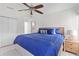 Bright bedroom with a ceiling fan, en-suite bath, and blue bedding in a light and airy room at 753 Lake Frances Dr, Charleston, SC 29412