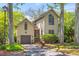 Charming two-story home with a well-manicured lawn and a driveway leading to an attached garage at 753 Lake Frances Dr, Charleston, SC 29412