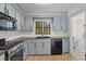 Well-lit kitchen boasting custom cabinetry, solid countertops and stainless steel appliances at 753 Lake Frances Dr, Charleston, SC 29412