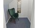 An office nook with a vintage green chair and blue patterned carpeting at 753 Lake Frances Dr, Charleston, SC 29412