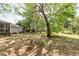 Serene backyard showcasing mature trees, a bird bath, and a lush lawn, perfect for outdoor activities at 783 Dills Bluff Rd, Charleston, SC 29412