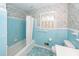 Bathroom with blue tile, floral wallpaper, and a bathtub with shower at 783 Dills Bluff Rd, Charleston, SC 29412