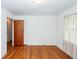 A minimalist bedroom featuring hardwood floors, white walls, and closet space at 783 Dills Bluff Rd, Charleston, SC 29412