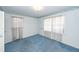 Spacious bedroom featuring carpeted floors, floral wallpaper border, and natural light at 783 Dills Bluff Rd, Charleston, SC 29412