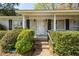 Close-up view of the front door and entry featuring brick accents and manicured shrubbery at 783 Dills Bluff Rd, Charleston, SC 29412