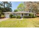 Traditional home showcasing a well-maintained lawn and established landscaping adding to its charm at 783 Dills Bluff Rd, Charleston, SC 29412