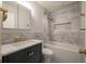 Modern bathroom featuring a sleek vanity, marble tiling, and a bathtub with shower at 8 Poulnot Ln, Charleston, SC 29401