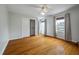 Bright bedroom featuring hardwood floors, closet, ceiling fan, and windows with natural light at 8 Poulnot Ln, Charleston, SC 29401