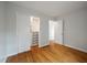 Bright bedroom featuring hardwood floors, closet with sliding doors, and neutral paint at 8 Poulnot Ln, Charleston, SC 29401