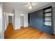 Stylish bedroom featuring a Murphy bed, hardwood floors, and a window with neighborhood views at 8 Poulnot Ln, Charleston, SC 29401