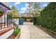 Long driveway leading to a charming house, framed by lush greenery and a blue gate at 8 Poulnot Ln, Charleston, SC 29401