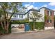 Elegant home with blue trim, white facade, lush ivy, and a charming blue gate entrance at 8 Poulnot Ln, Charleston, SC 29401