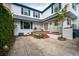 A charming white house exterior is shown with red brick steps leading to the front door at 8 Poulnot Ln, Charleston, SC 29401