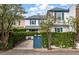 Charming two-story white home with blue shutters and a vine-covered wall for added privacy at 8 Poulnot Ln, Charleston, SC 29401