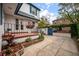This exterior view captures the garden space, complemented by brick accents, leading to a charming blue gate at 8 Poulnot Ln, Charleston, SC 29401