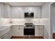 Bright kitchen features modern appliances, white cabinetry, and a stylish tile backsplash at 8 Poulnot Ln, Charleston, SC 29401
