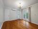 An airy living room showcases hardwood floors, neutral walls, and French doors with views of the outside at 8 Poulnot Ln, Charleston, SC 29401
