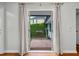 Charming patio view with potted plants and privacy hedge, accessible through glass doors at 8 Poulnot Ln, Charleston, SC 29401