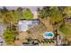 A high angle shot showcases a pristine pool nestled within a lush, tree-filled yard at 803 S Main St, Summerville, SC 29483