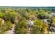 A quaint home nestled amongst lush trees. The aerial shot captures a serene neighborhood at 803 S Main St, Summerville, SC 29483