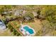 Breathtaking aerial view features the sparkling pool and a home surrounded by mature trees at 803 S Main St, Summerville, SC 29483
