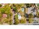 Aerial view of property with a pool, surrounded by lush trees and adjacent to parking at 803 S Main St, Summerville, SC 29483