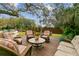 Backyard with a deck, outdoor seating, a stone table, and mature shade trees at 803 S Main St, Summerville, SC 29483
