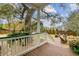 Deck overlooking an expansive backyard, mature trees, and outdoor seating area at 803 S Main St, Summerville, SC 29483