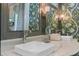 Charming bathroom with a double sink vanity, floral wallpaper, and stylish fixtures at 803 S Main St, Summerville, SC 29483