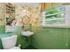 Bathroom showcasing vintage green tiling, a sink, and a window with natural light at 803 S Main St, Summerville, SC 29483