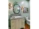 Elegant bathroom featuring a decorative mirror, a marble countertop, and sconce lighting at 803 S Main St, Summerville, SC 29483