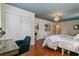 Bedroom featuring hardwood flooring, an ensuite, a chandelier, and a closet at 803 S Main St, Summerville, SC 29483