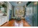 Bedroom with custom cabinetry, hardwood floors, and a bright workspace with a large window at 803 S Main St, Summerville, SC 29483